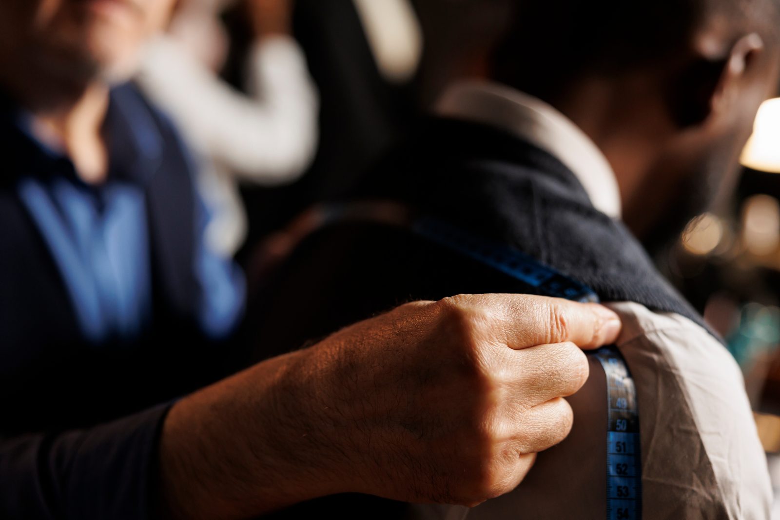 A tailor measuring a bespoke suit